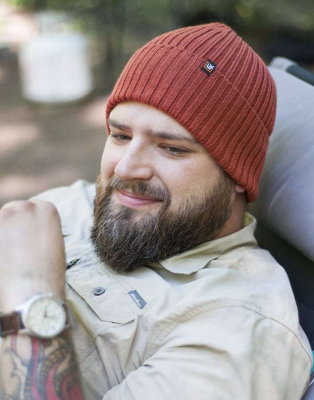 man wearing copper red wool hat