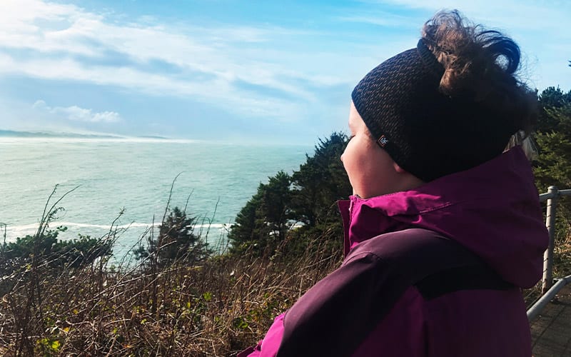 girl wearing headband looking at ocean